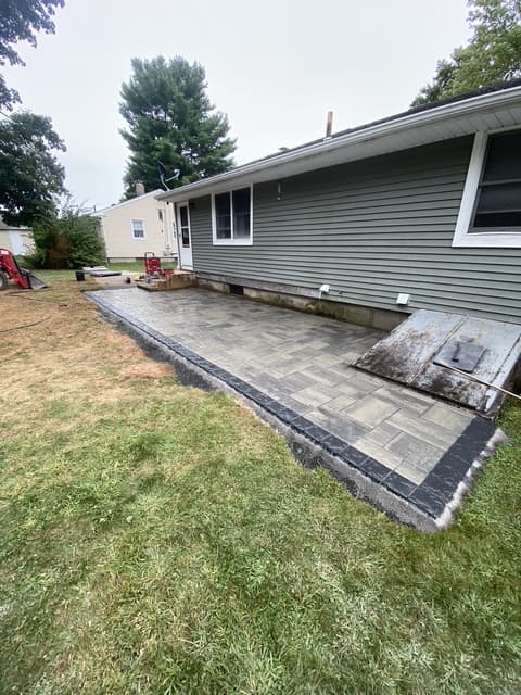 Bluestone paver patio installation along home exterior